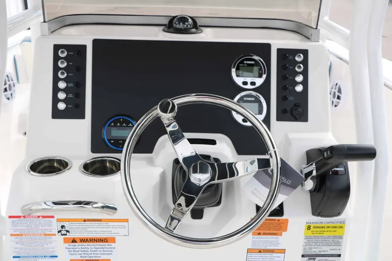 Slide: The Image of The image shows the helm of a Robalo R200 Center Console boat with modern instruments. - 47