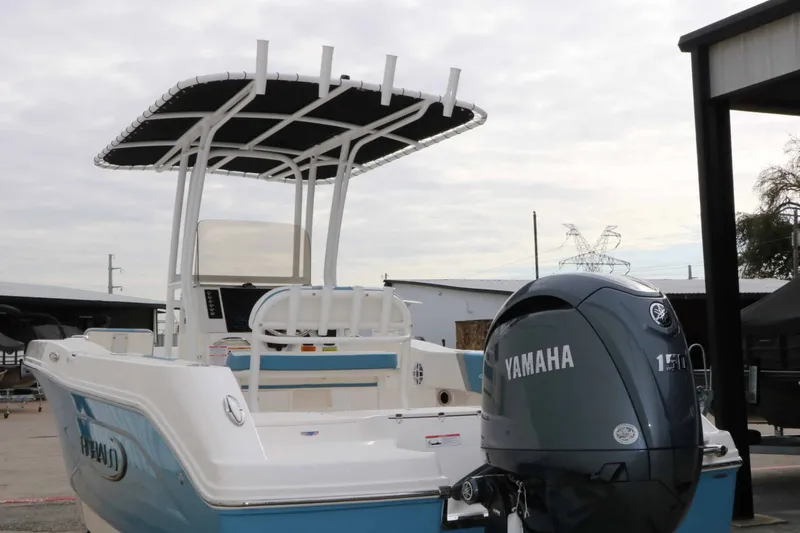 Slide: The Image of A Robalo R200 Center Console boat with a Yamaha engine, parked at a dock. - 19