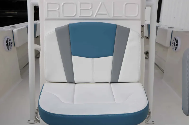 Slide: The Image of Seat with blue and white upholstery and Robalo logo in the background. - 43