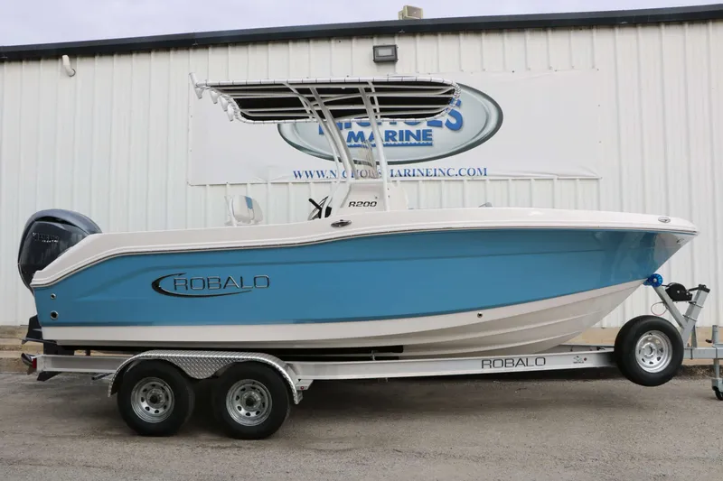 Slide: The Image of Robalo R200 Center Console 2027 on a trailer in front of a building. - 3