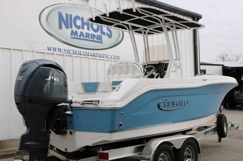 Slide: The Image of Robalo R200 Center Console 2027 with blue hull and Yamaha outboard motor on a trailer. - 14