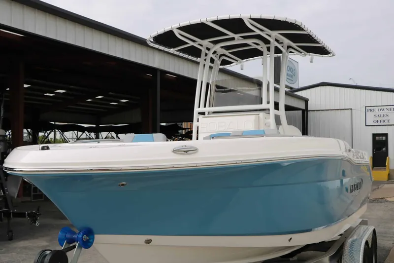 Slide: The Image of A 2027 Robalo R200 Center Console boat with a blue hull is on a trailer. - 24