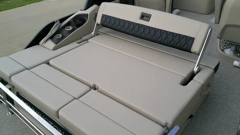 Slide: The Image of The image shows a beige lounging area on a boat with black accents and cup holders. - 13