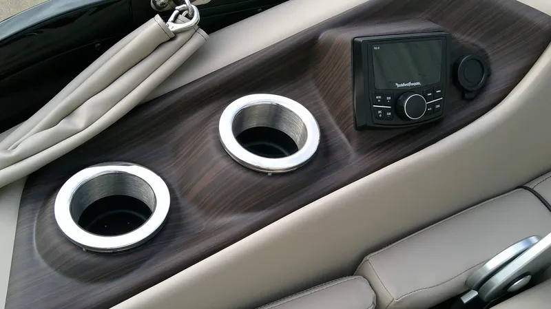 Slide: The Image of The image shows a boat console with two cup holders and a control unit. - 14