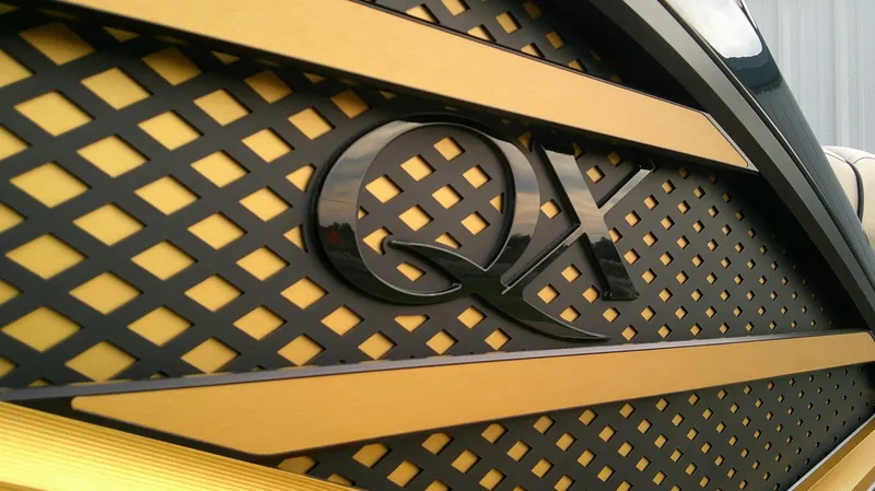 Slide: The Image of Close-up of a stylish, gold lattice with the "QX" lettering. - 18