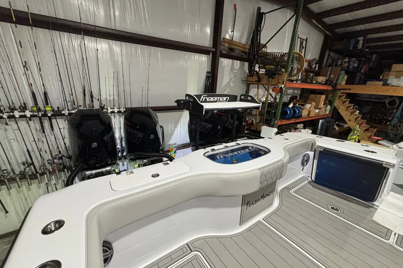 Slide: The Image of Freeman 38 boat interior with fishing rods and dual engines, 2025 model. - 19