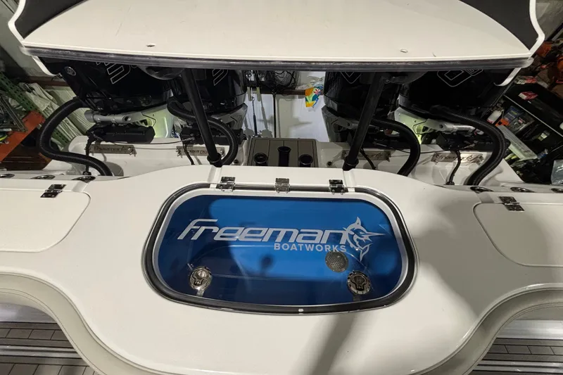 Slide: The Image of Freeman 38 boat deck with logo, featuring dual engines, 2025 model. - 20