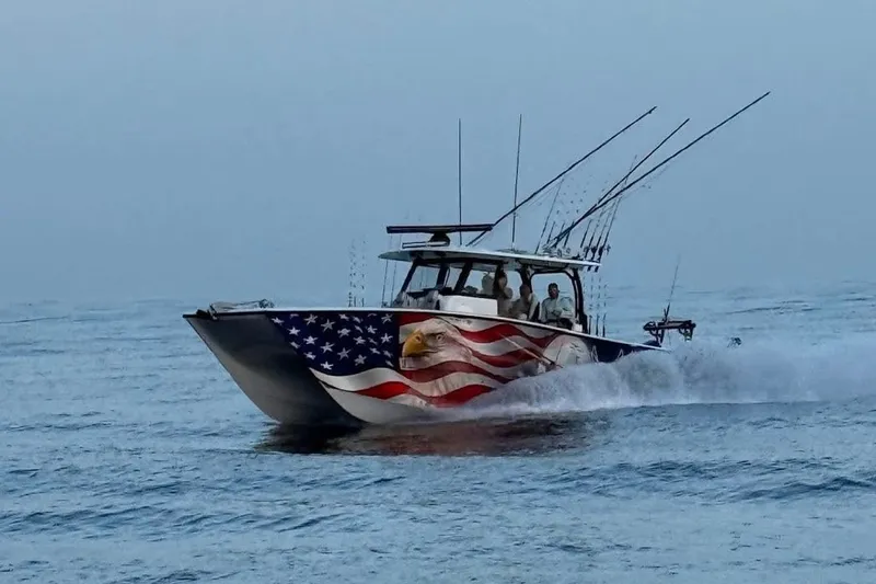 The Image of A Freeman 38 boat from 2025 with American flag design speeding on the ocean. - 0