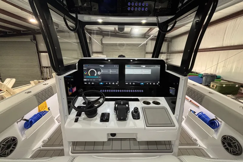 Slide: The Image of Modern Freeman 38 boat cockpit with advanced controls and touchscreen display, 2025 model. - 14