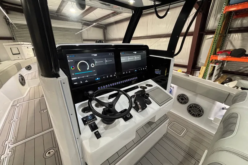 Slide: The Image of 2025 Freeman 38 boat cockpit with advanced navigation screens and modern steering controls. - 13