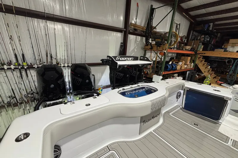 Slide: The Image of 2025 Freeman 38 boat in storage, featuring dual engines and fishing equipment. - 22