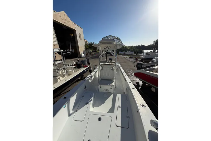 Slide: The Image of 2007 Andros 26 Tarpon boat docked, showcasing spacious deck and seating area. - 10