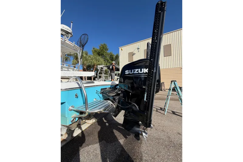 Slide: The Image of 2007 Andros 26 Tarpon boat with Suzuki outboard motor, parked outdoors. - 5