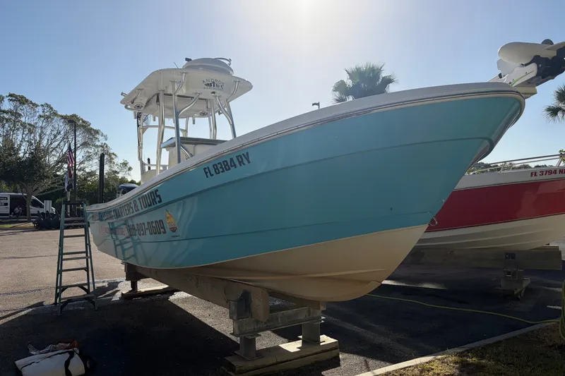 The Image of 2007 Andros 26 Tarpon boat on display, light blue hull, parked outdoors. - 0