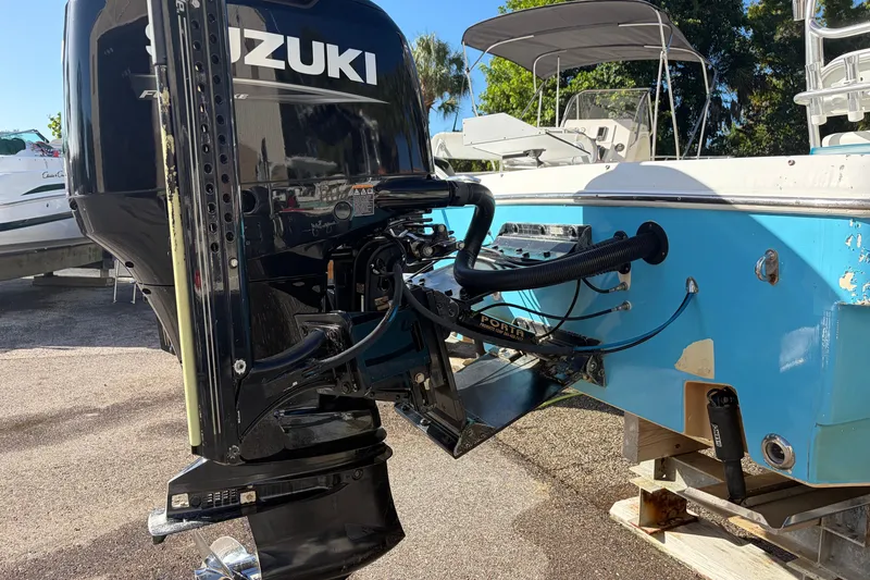 Slide: The Image of 2007 Andros 26 Tarpon boat with Suzuki outboard motor, parked on a sunny day. - 4