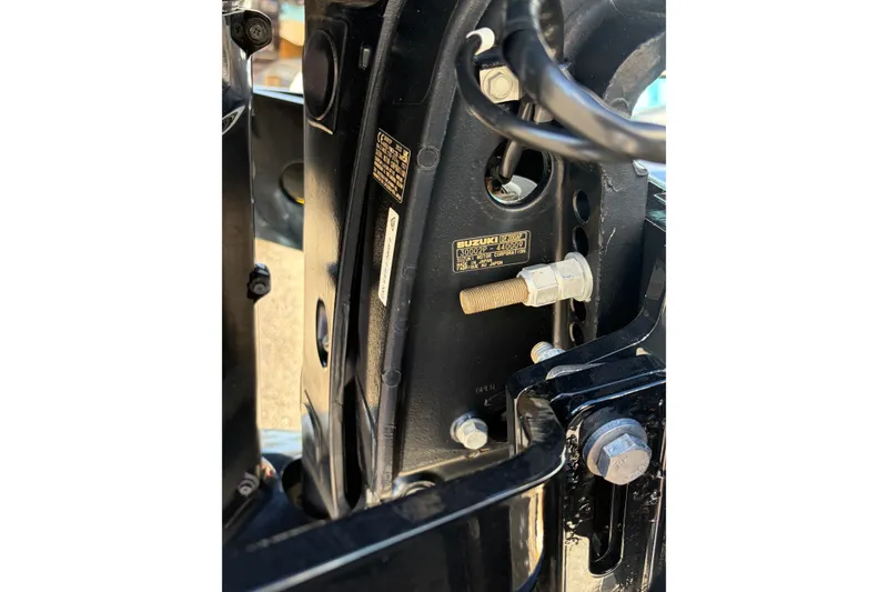 Slide: The Image of Close-up of a 2007 Andros 26 Tarpon boat engine component with visible Suzuki label. - 29