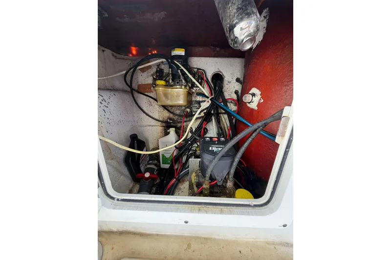 Slide: The Image of 2007 Andros 26 Tarpon boat engine compartment with wiring and components. - 28