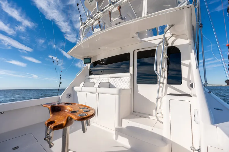 Slide: The Image of 2005 Viking 45 Convertible yacht deck with seating, ladder, and ocean view. - 19