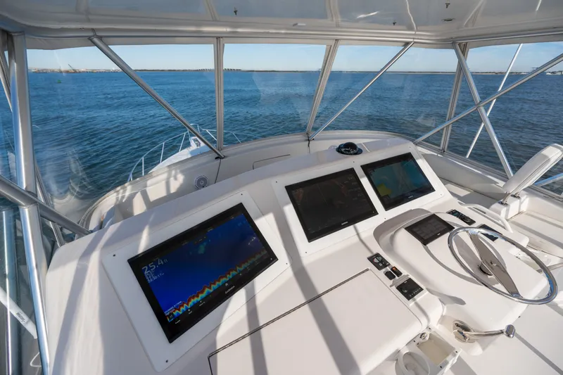 Slide: The Image of Helm of 2005 Viking 45 Convertible yacht with navigation screens and steering wheel. - 16