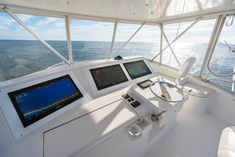 Slide: The Image of Helm of 2005 Viking 45 Convertible yacht with navigation screens and ocean view. - 17