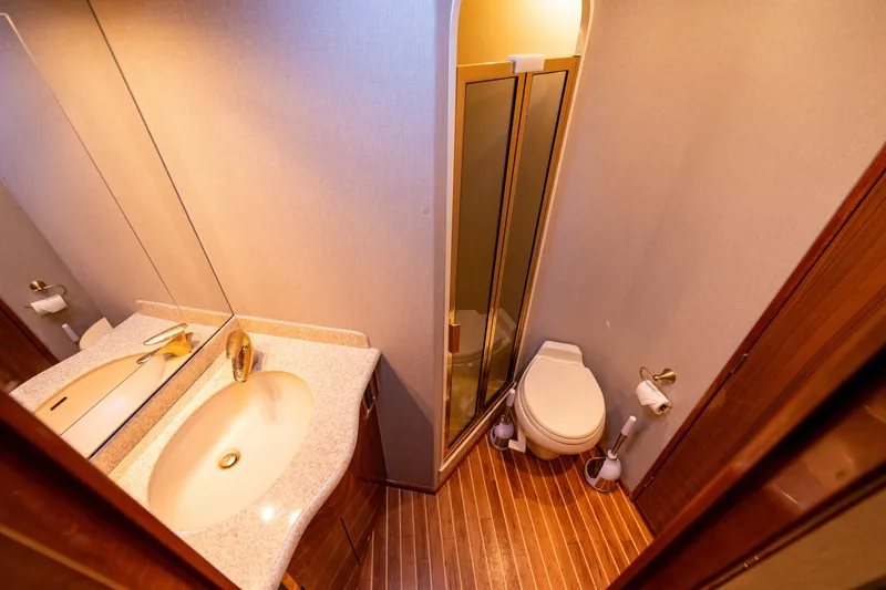 Slide: The Image of Bathroom interior of 2005 Viking 45 Convertible yacht with sink, toilet, and shower. - 31