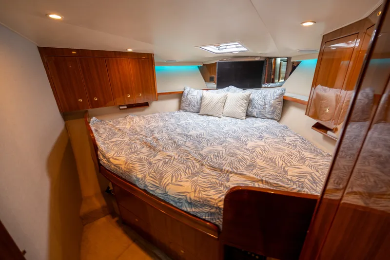 Slide: The Image of Luxurious cabin interior of 2005 Viking 45 Convertible yacht with cozy bedding. - 27