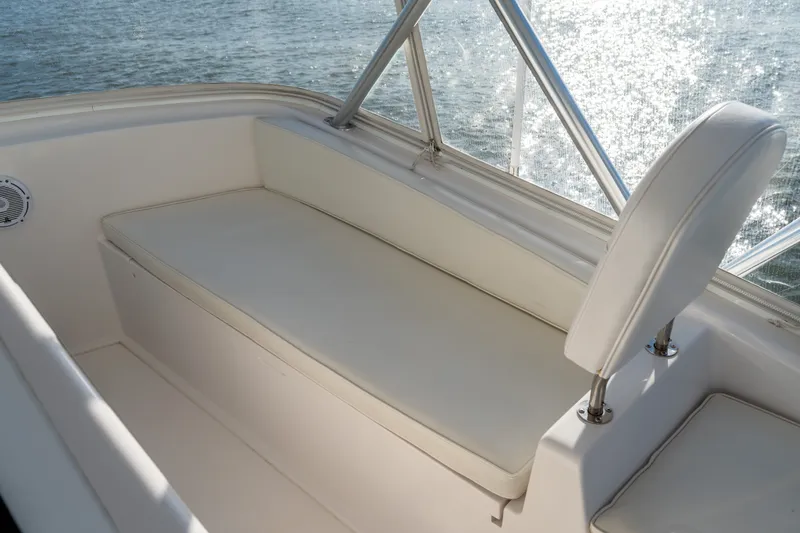 Slide: The Image of White seating area on 2005 Viking 45 Convertible boat, overlooking sparkling water. - 18