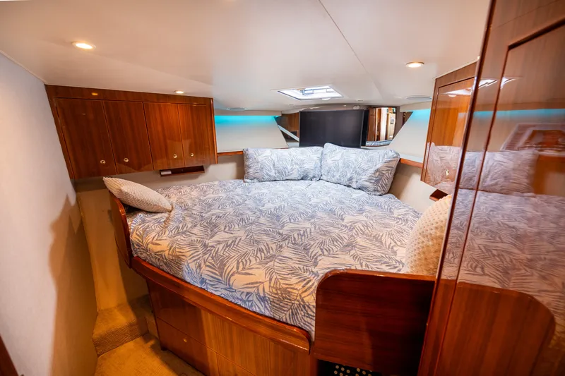 Slide: The Image of Luxurious cabin interior of 2005 Viking 45 Convertible yacht with cozy bedding. - 28