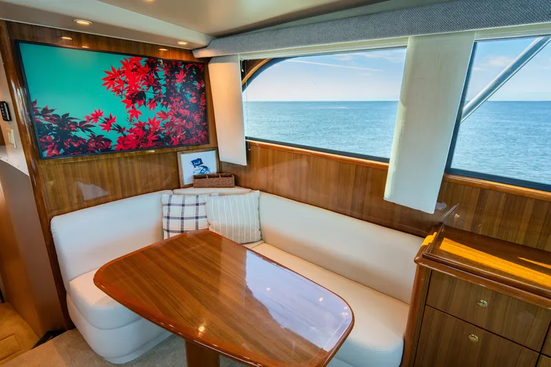 Slide: The Image of Interior of 2005 Viking 45 Convertible yacht with ocean view and elegant seating area. - 25