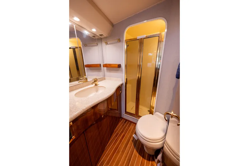 Slide: The Image of Luxurious bathroom in 2005 Viking 45 Convertible yacht with wood accents and modern fixtures. - 30