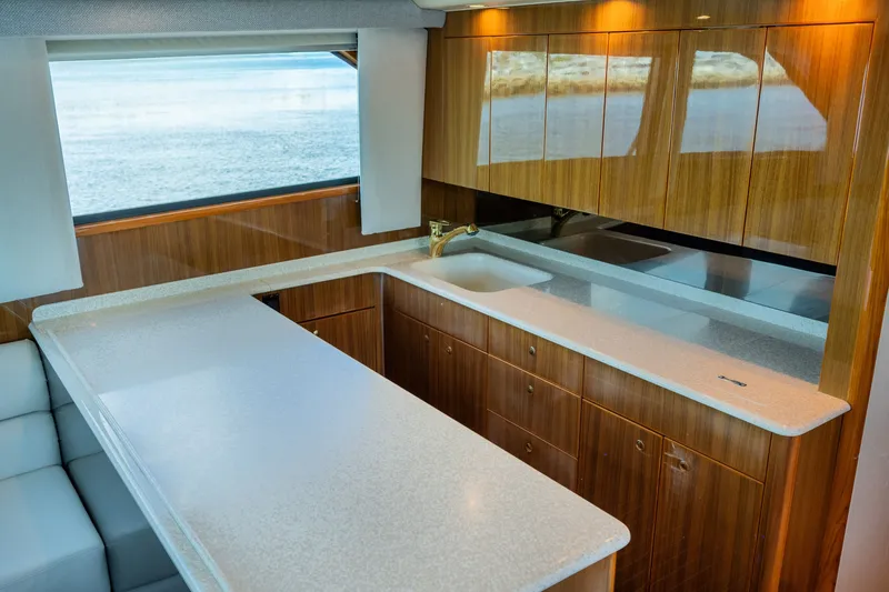 Slide: The Image of Luxurious kitchen interior of 2005 Viking 45 Convertible yacht with wood cabinetry and ocean view. - 26