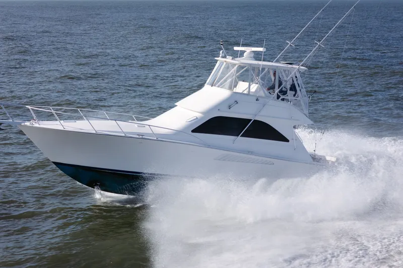 Slide: The Image of 2005 Viking 45 Convertible yacht cruising swiftly on open water. - 13