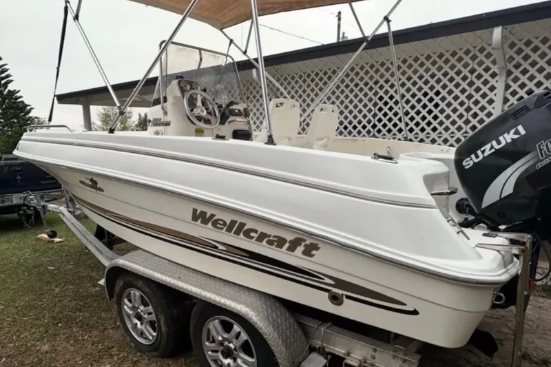 Slide: The Image of 2003 Wellcraft 200 Fisherman boat on trailer with Suzuki outboard motor. - 3