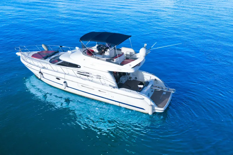 Slide: The Image of 2002 Cranchi Atlantique 50 yacht cruising on clear blue water. - 3