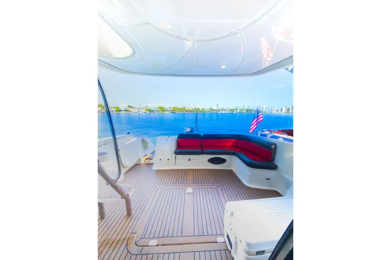 Slide: The Image of Cranchi Atlantique 50 yacht deck with seating, overlooking serene blue waters, 2002 model. - 7
