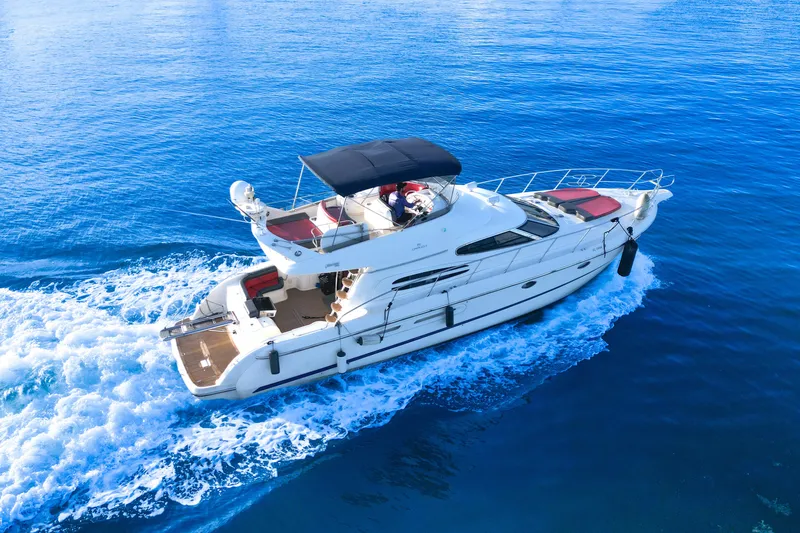 Slide: The Image of 2002 Cranchi Atlantique 50 yacht cruising on clear blue water. - 2