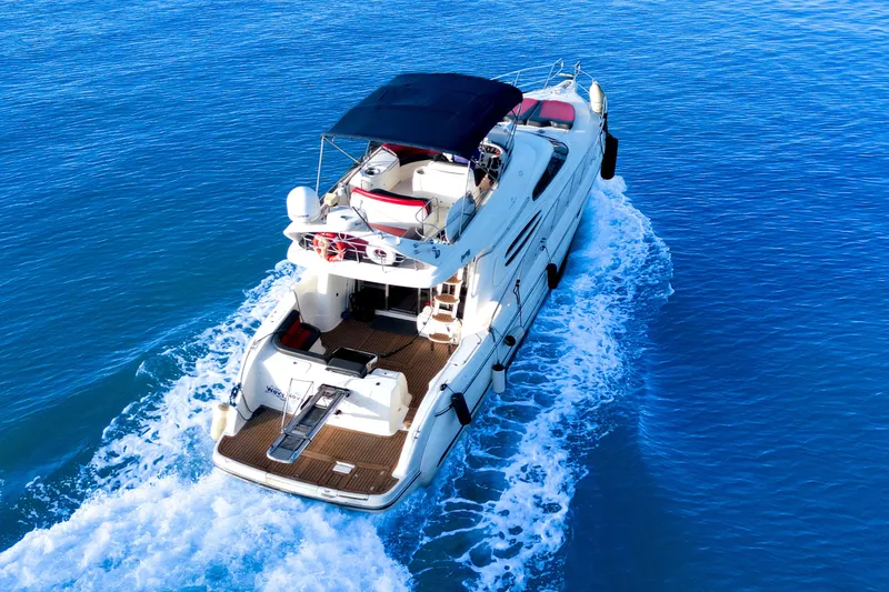 Slide: The Image of Luxurious 2002 Cranchi Atlantique 50 yacht cruising on clear blue waters. - 1