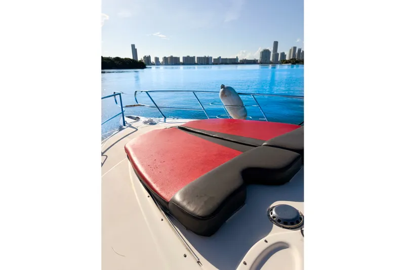 Slide: The Image of Cranchi Atlantique 50 yacht deck with red cushions, city skyline in background, 2002 model. - 11