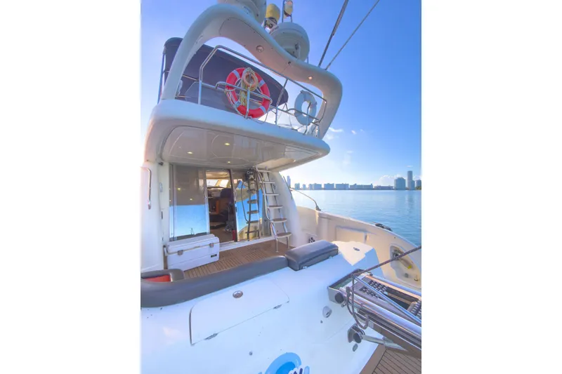 Slide: The Image of 2002 Cranchi Atlantique 50 yacht with upper deck, docked by calm waters. - 5