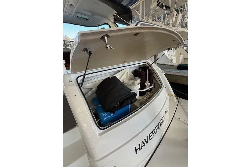 Slide: The Image of Open storage compartment on 2006 Formula 40 Performance Cruiser, filled with boating gear. - 18