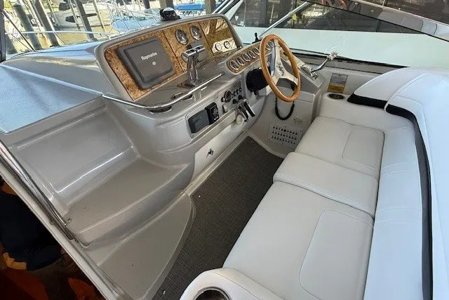 Slide: The Image of 2006 Formula 40 Performance Cruiser cockpit with white seating and wooden steering wheel. - 11