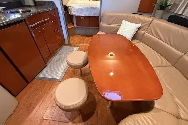 Slide: The Image of 2006 Formula 40 Performance Cruiser interior with wooden table, leather seating, and compact kitchen. - 43