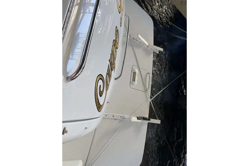 Slide: The Image of 2006 Formula 40 Performance Cruiser boat stern with decorative lettering and water reflection. - 21