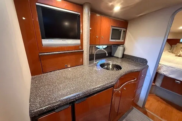 Slide: The Image of 2006 Formula 40 Performance Cruiser interior with kitchenette, TV, and microwave. - 19