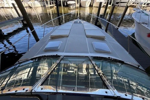 Slide: The Image of 2006 Formula 40 Performance Cruiser docked, showcasing sleek design and spacious deck. - 5