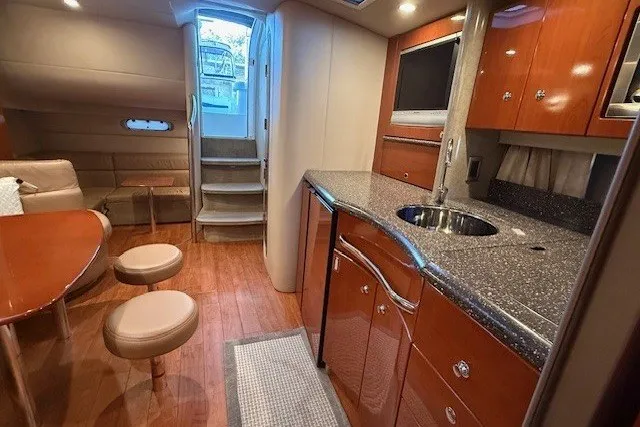 Slide: The Image of Interior of a 2006 Formula 40 Performance Cruiser with modern kitchen and seating area. - 40