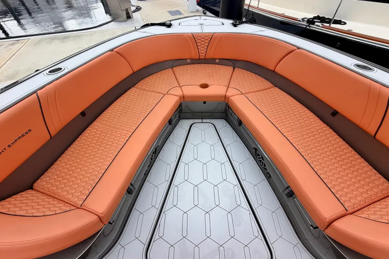 Slide: The Image of Luxurious orange seating on 2025 Midnight Express 43 Solstice boat, docked at marina. - 11