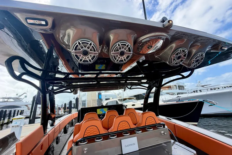 Slide: The Image of 2025 Midnight Express 43 Solstice boat interior with orange seating and overhead speakers. - 3