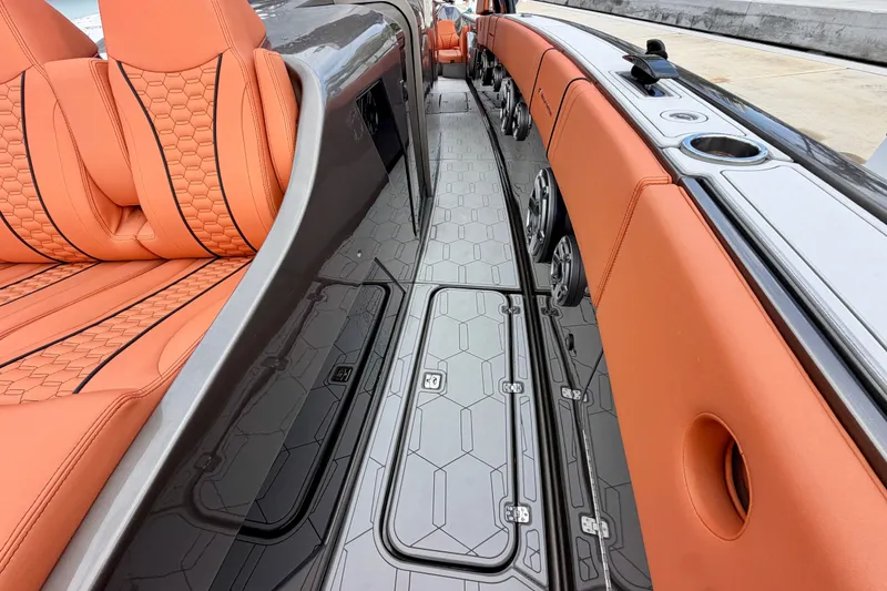 Slide: The Image of Luxurious interior of 2025 Midnight Express 43 Solstice boat with orange seating and sleek design. - 12