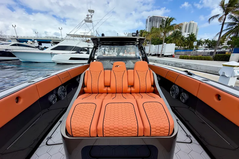 Slide: The Image of Luxurious 2025 Midnight Express 43 Solstice boat with orange seating at a marina. - 9